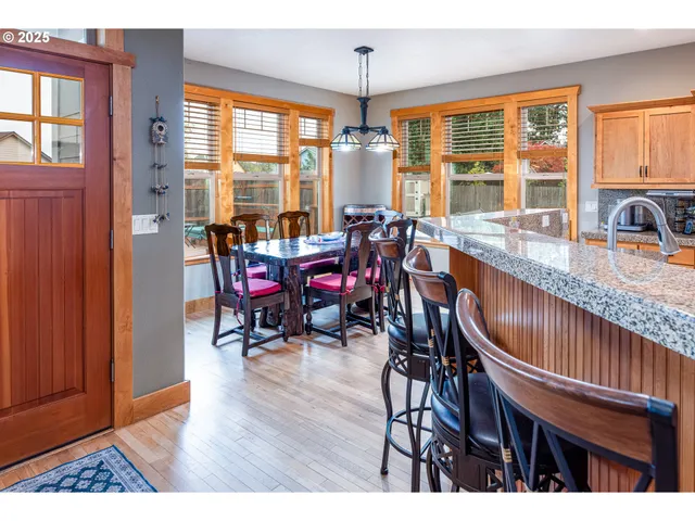 a dining room with furniture window and wooden floor