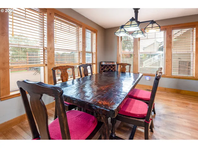 a dining room with furniture a chandelier and wooden floor
