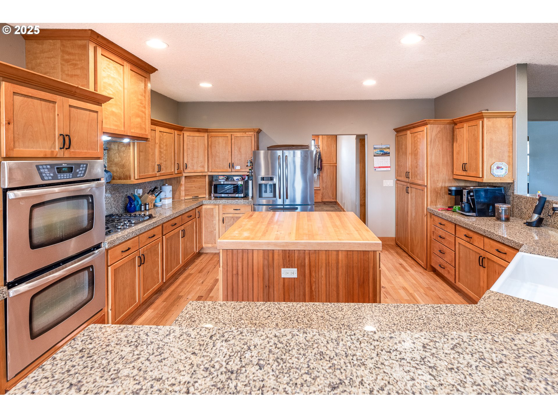 3215 54th Avenue Northeast Albany, OR 97321 - Photo 15 of 45 a large kitchen with stainless steel appliances granite countertop a stove a sink and a refrigerator