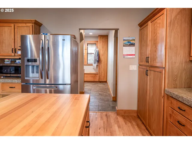a kitchen with stainless steel appliances a refrigerator and wooden cabinets