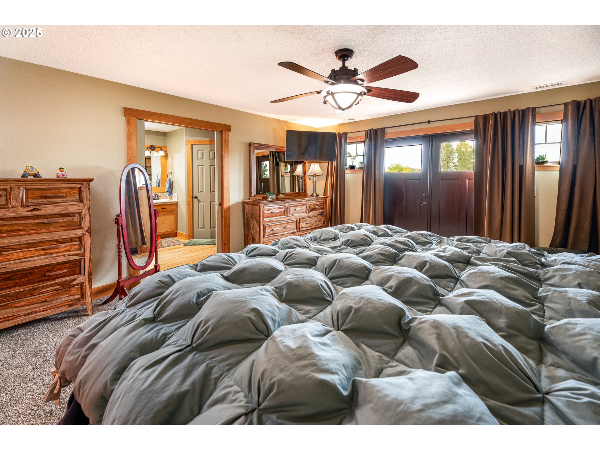 3215 54th Avenue Northeast Albany, OR 97321 - Photo 29 of 45 a bedroom with a large bed and a chandelier