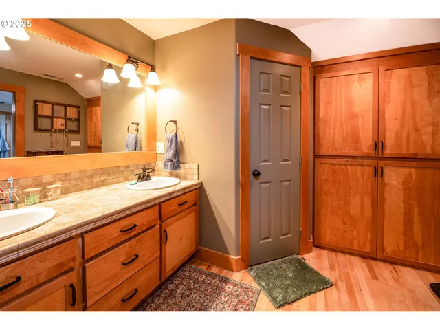 a bathroom with a sink a mirror and a shower