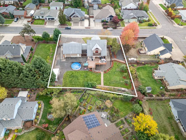 aerial view of a house with a garden and lake view