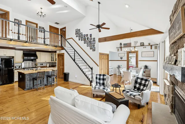 a view of a livingroom with furniture outdoor kitchen view and a large window