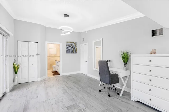 a view of a workspace with furniture and wooden floor