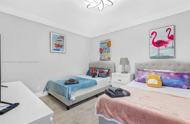 a bedroom with furniture and painting on the wall