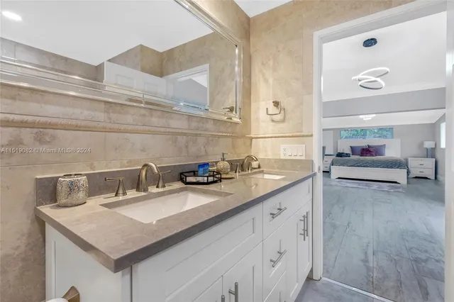 a kitchen with a sink and a stove with wooden floor