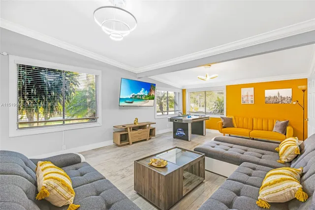 a living room with furniture and a flat screen tv