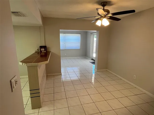 a view of a livingroom with furniture and chandelier fan