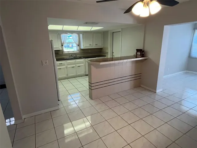 a kitchen with white cabinets and white appliances