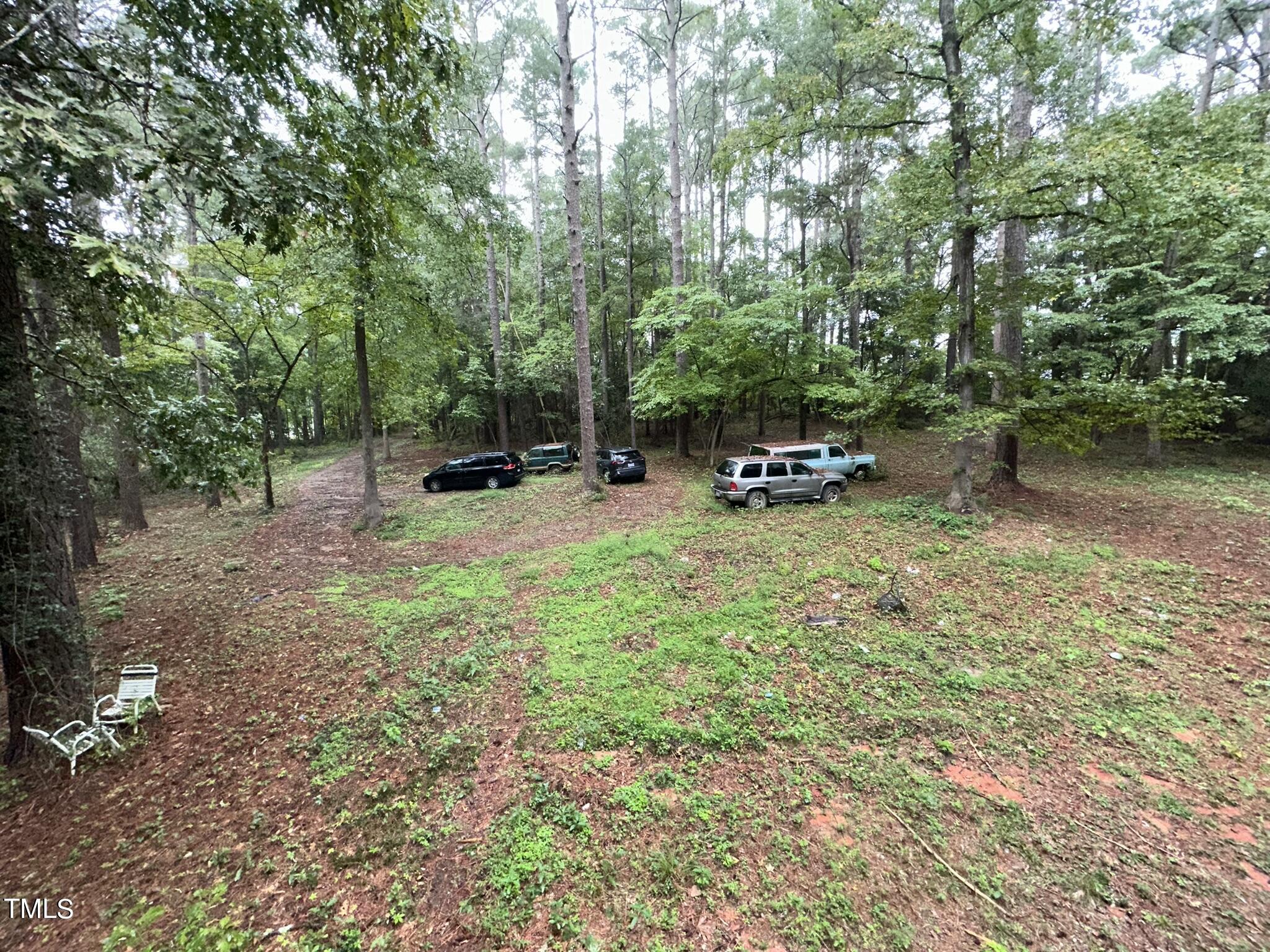 293 Nicholson Road Rockingham, NC 28379 - Photo 14 of 55 a view of a backyard with table and chairs and a large tree