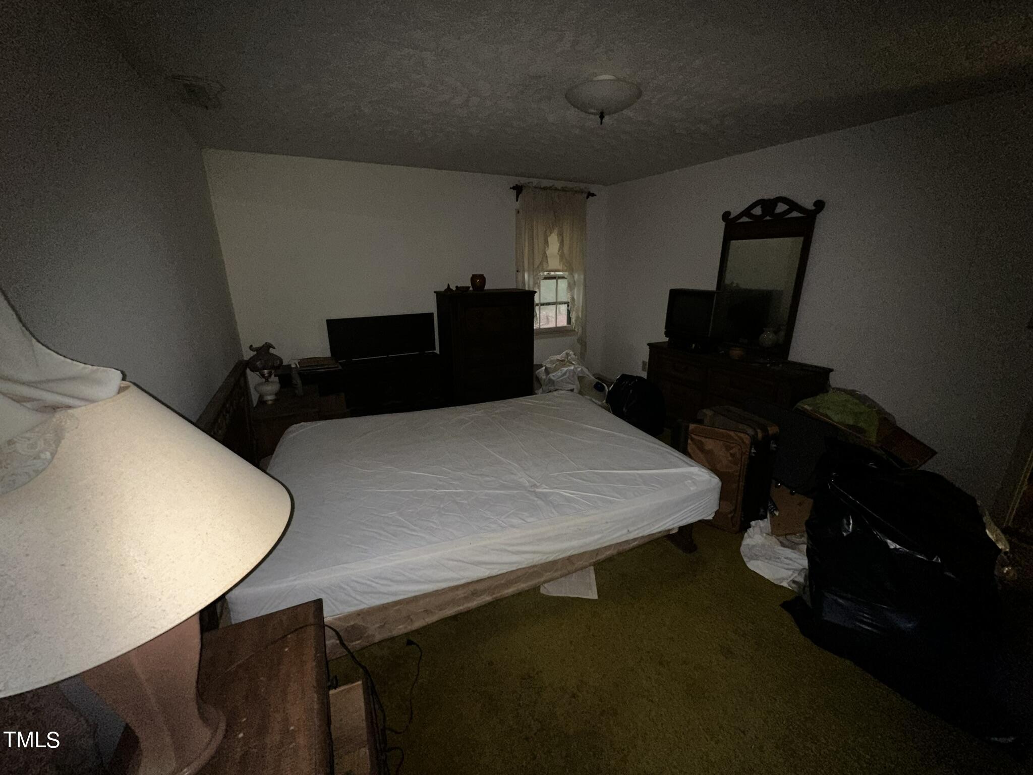 293 Nicholson Road Rockingham, NC 28379 - Photo 47 of 55 a bed sitting in a bedroom next to a window