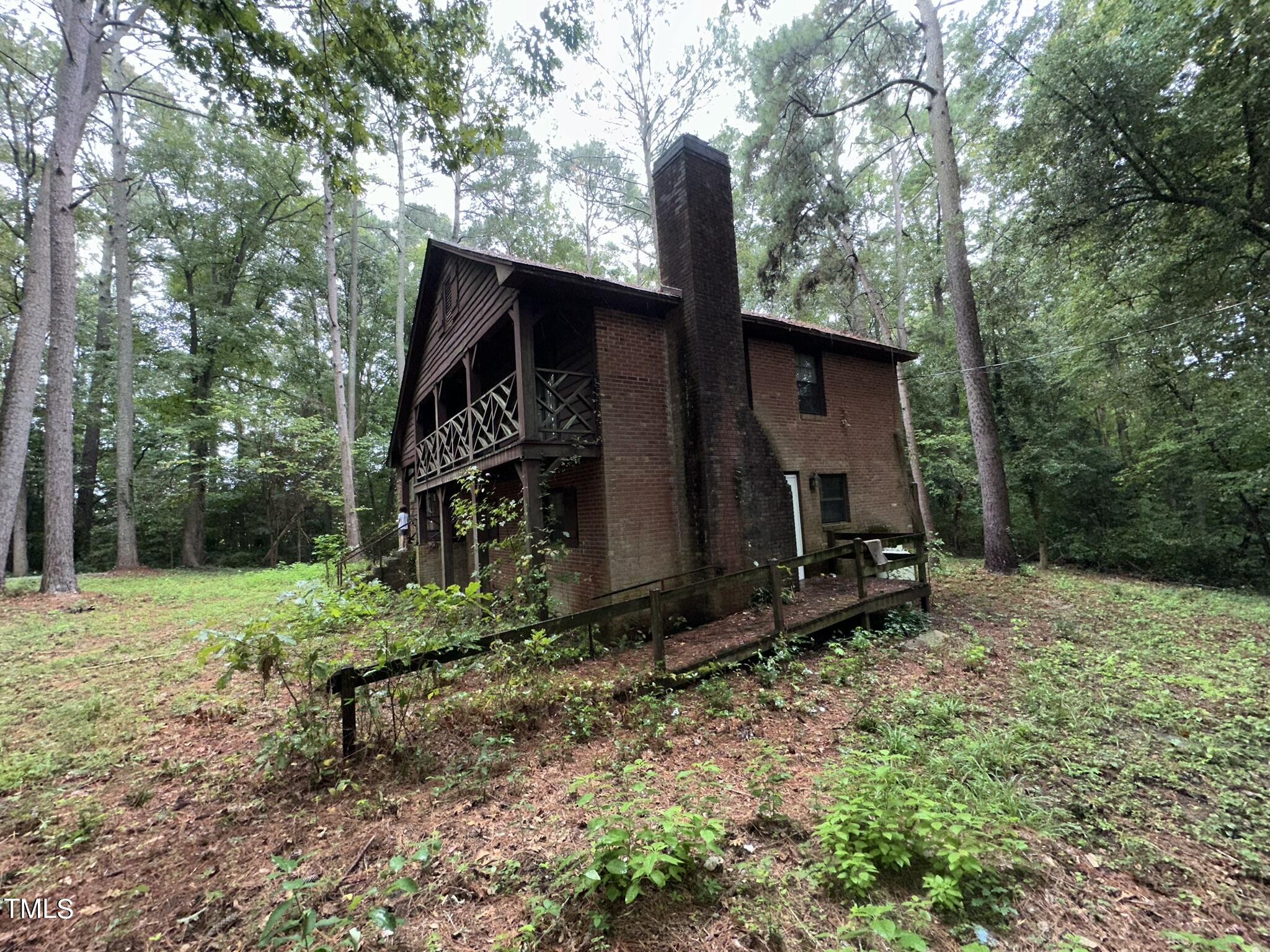 293 Nicholson Road Rockingham, NC 28379 - Photo 10 of 55 a barn house with a yard and wooden fence