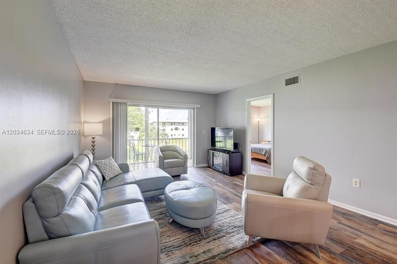 9880 Marina Boulevard, Unit 1516 Boca Raton, FL 33428 - Photo 10 of 32 a living room with furniture and a large window