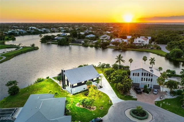 an aerial view of a house with garden space and lake view