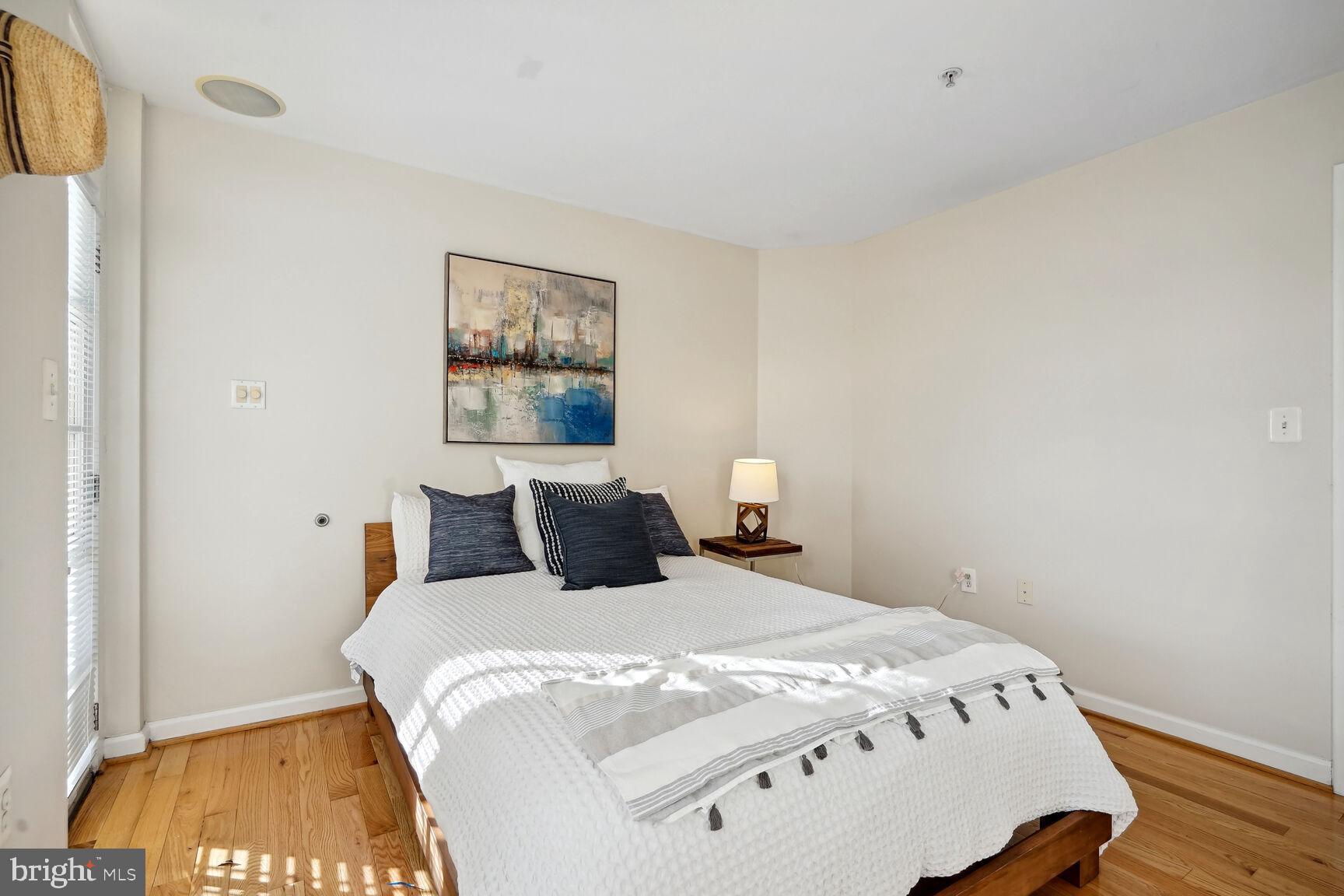 1308 Clifton Street Northwest, Unit 104 Washington, DC 20009 - Photo 13 of 24 a bedroom with a bed and a night stand