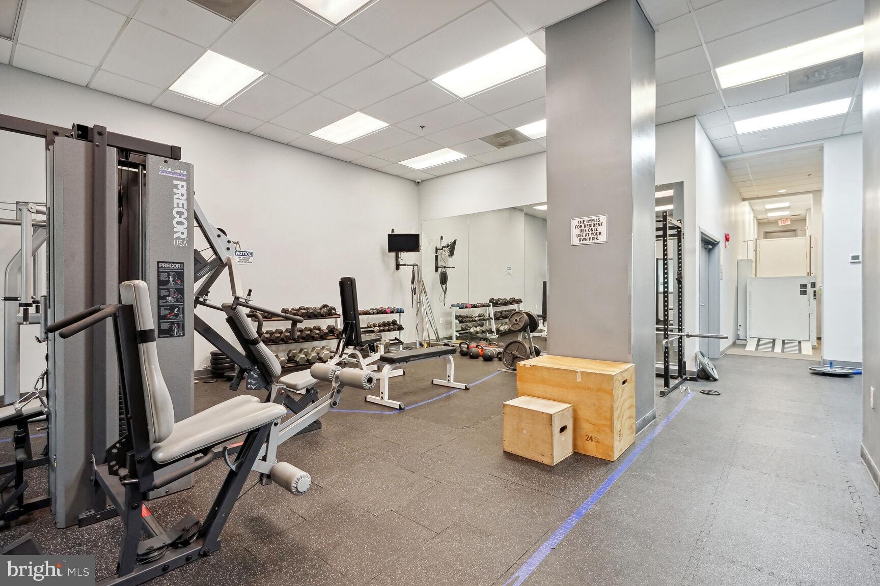 1308 Clifton Street Northwest, Unit 104 Washington, DC 20009 - Photo 20 of 24 a room with gym equipment and wooden floor
