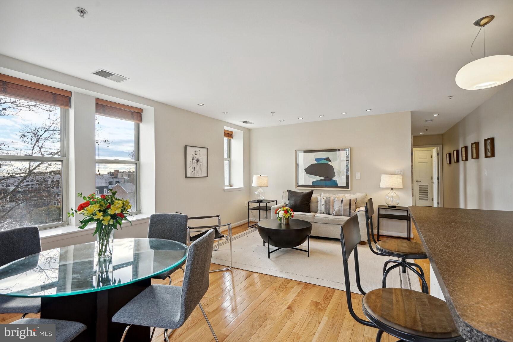 1308 Clifton Street Northwest, Unit 104 Washington, DC 20009 - Photo 3 of 24 a living room with furniture and a table