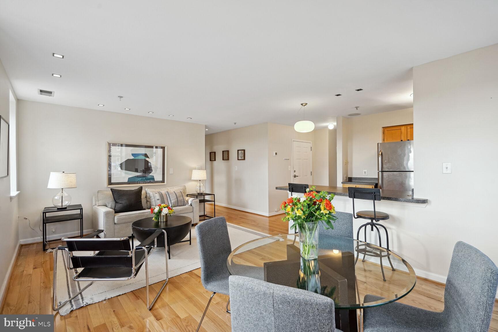 1308 Clifton Street Northwest, Unit 104 Washington, DC 20009 - Photo 4 of 24 a living room with furniture potted plant and a lamp