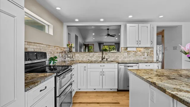 a kitchen with a sink stove and cabinets
