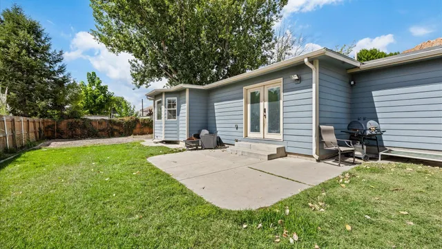 a backyard of a house with table and chairs