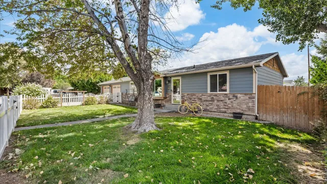 a backyard of a house with table and chairs