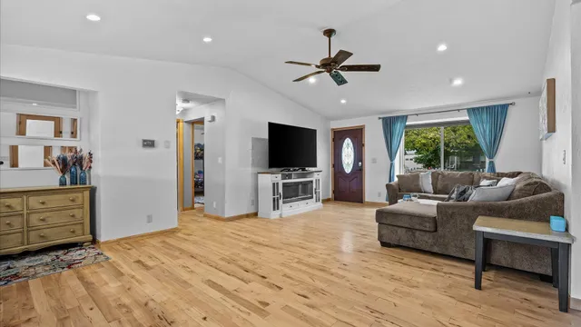 a living room with furniture flat screen tv and window