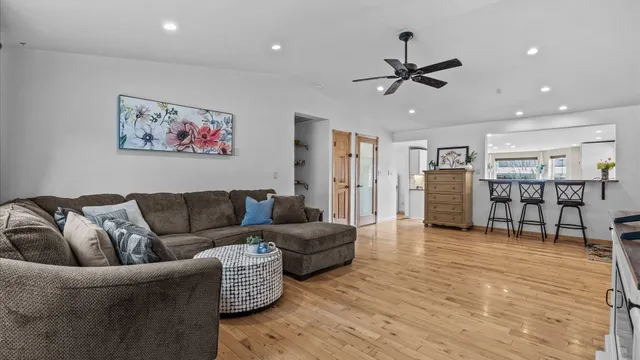 a living room with furniture and kitchen view