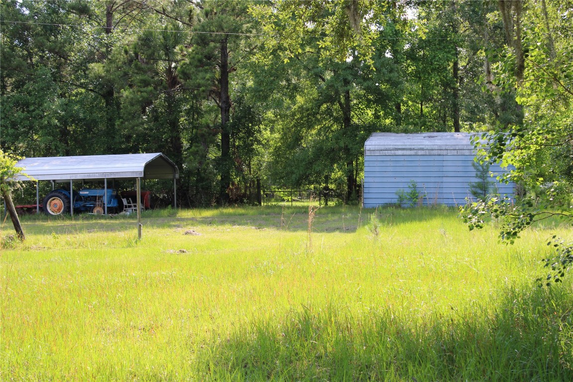 481218 Haddock Road Hilliard, FL 32046 - Photo 13 of 27 a view of a swimming pool with a patio