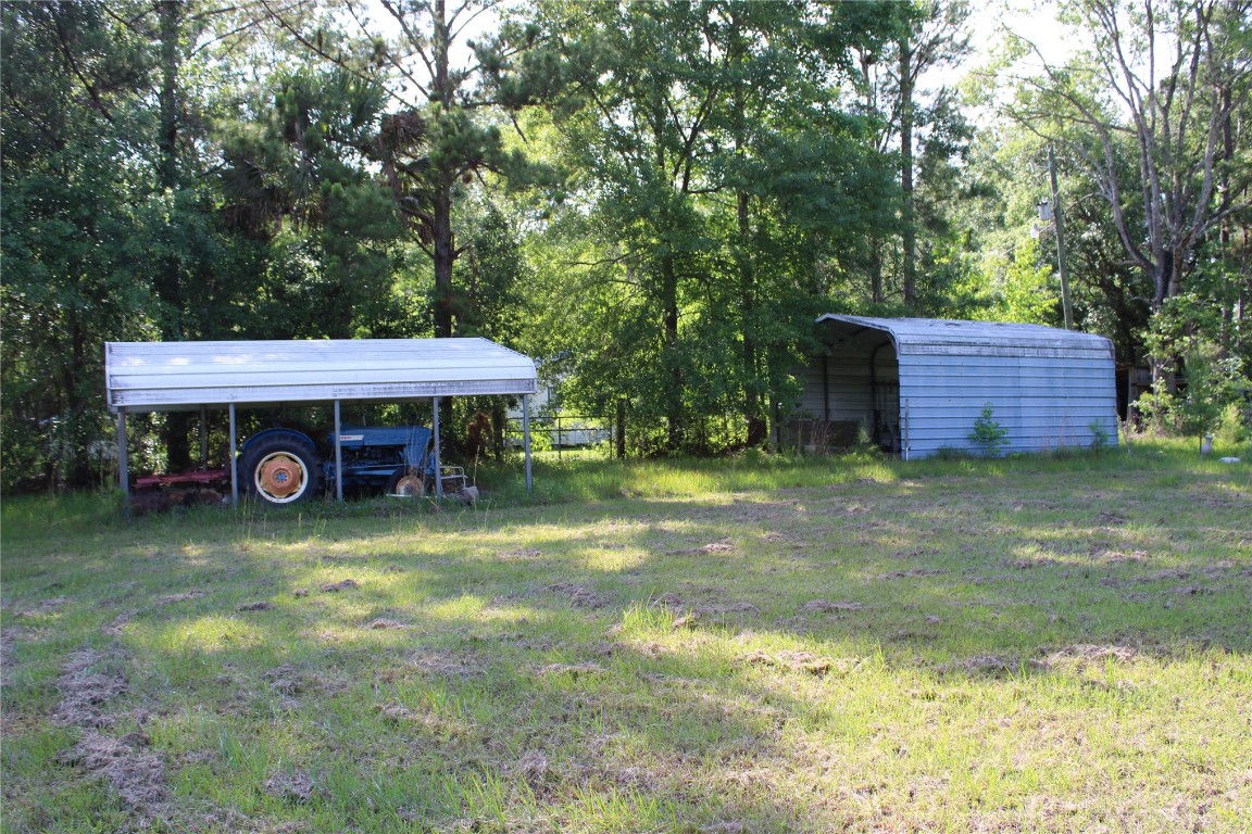 481218 Haddock Road Hilliard, FL 32046 - Photo 16 of 27 a view of a house with backyard