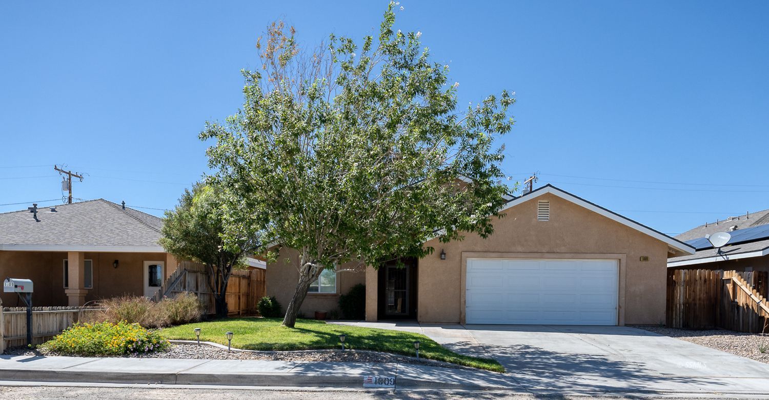 1009 Sims Street Ridgecrest, CA 93555 - Photo 2 of 40 a front view of a house with a garden