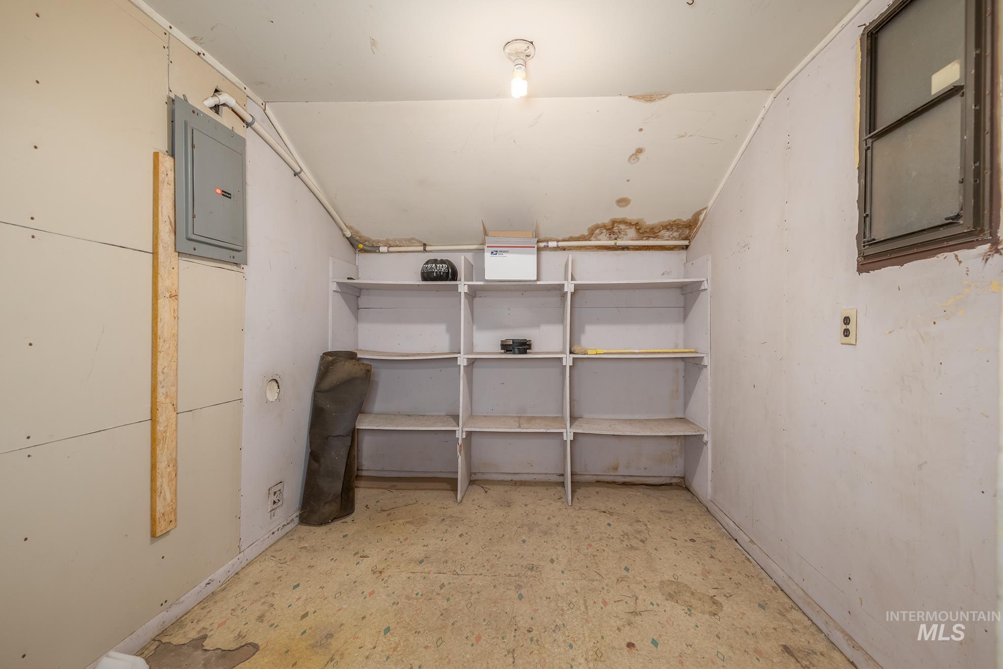 61 Southwest 4th Street Ontario, OR 97914 - Photo 40 of 42 Room with built-in shelving, a single window, and visible electrical panel