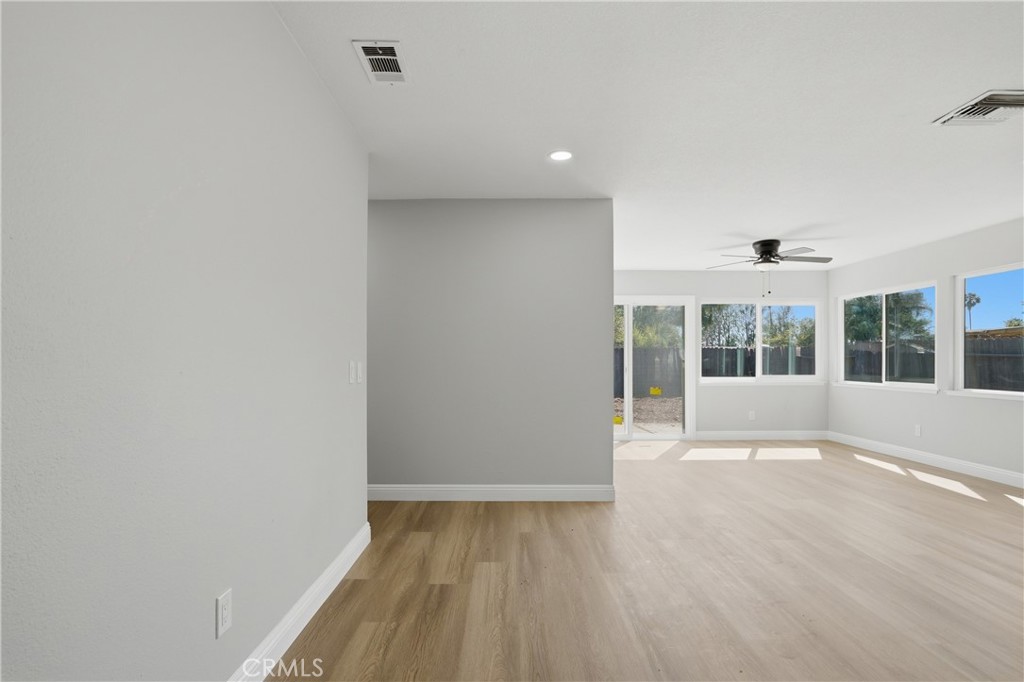 2924 Louisiana Place Riverside, CA 92506 - Photo 7 of 42 an empty room with wooden floor and windows