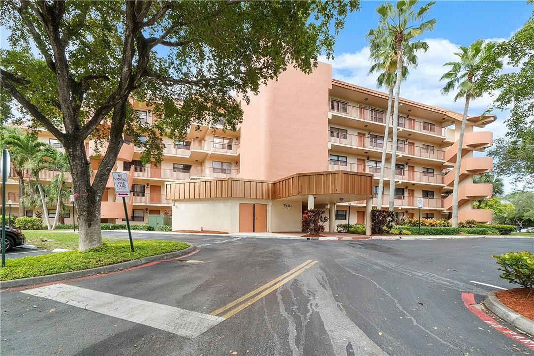 7401 Northwest 16th Street, Unit 103 Plantation, FL 33313 - Photo 1 of 12 a front view of a building with a garden