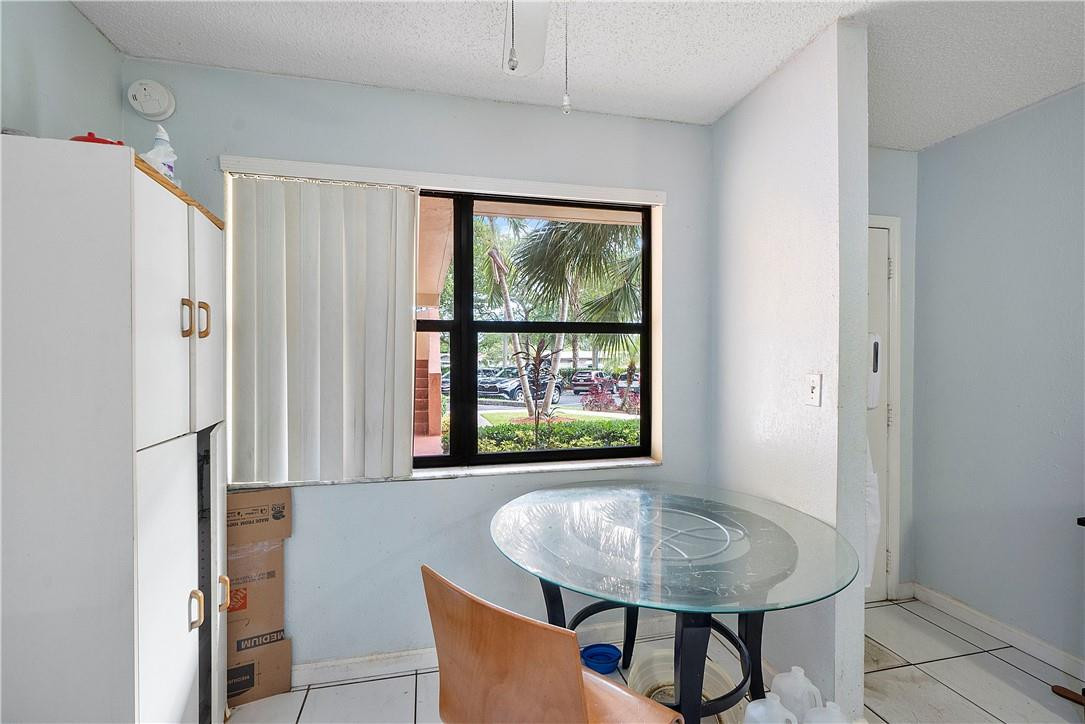 7401 Northwest 16th Street, Unit 103 Plantation, FL 33313 - Photo 5 of 12 a dining room with furniture and a window