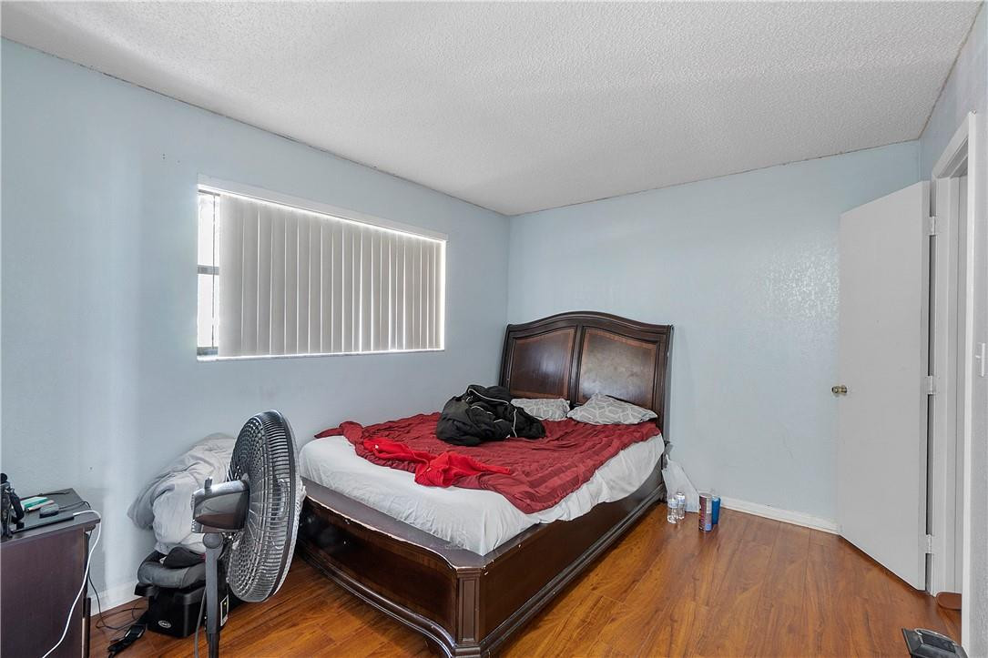 7401 Northwest 16th Street, Unit 103 Plantation, FL 33313 - Photo 6 of 12 a bedroom with a bed and a potted plant
