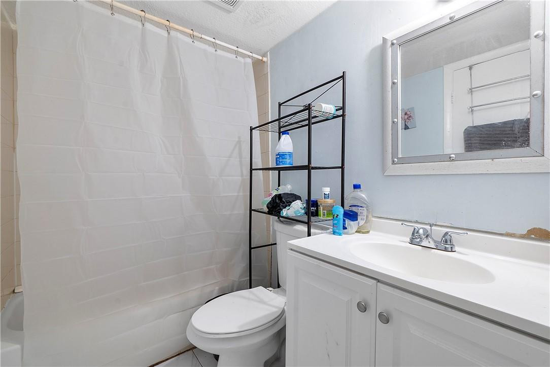 7401 Northwest 16th Street, Unit 103 Plantation, FL 33313 - Photo 9 of 12 a bathroom with a sink toilet and shower