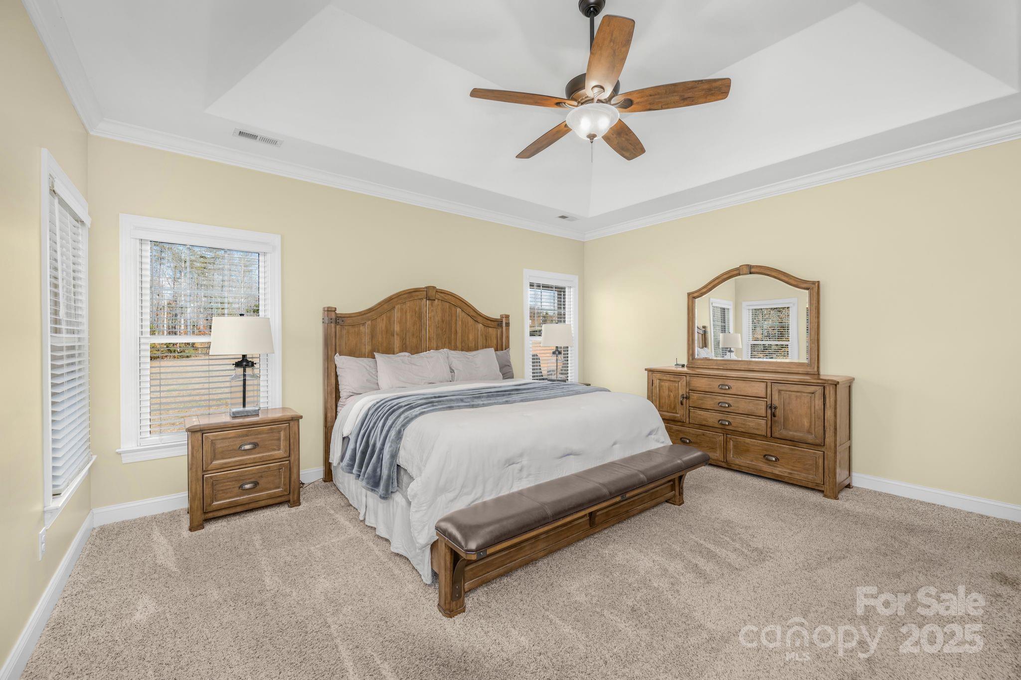 476 Ijames Church Road Mocksville, NC 27028 - Photo 17 of 48 a bedroom with a bed a ceiling fan and a dresser