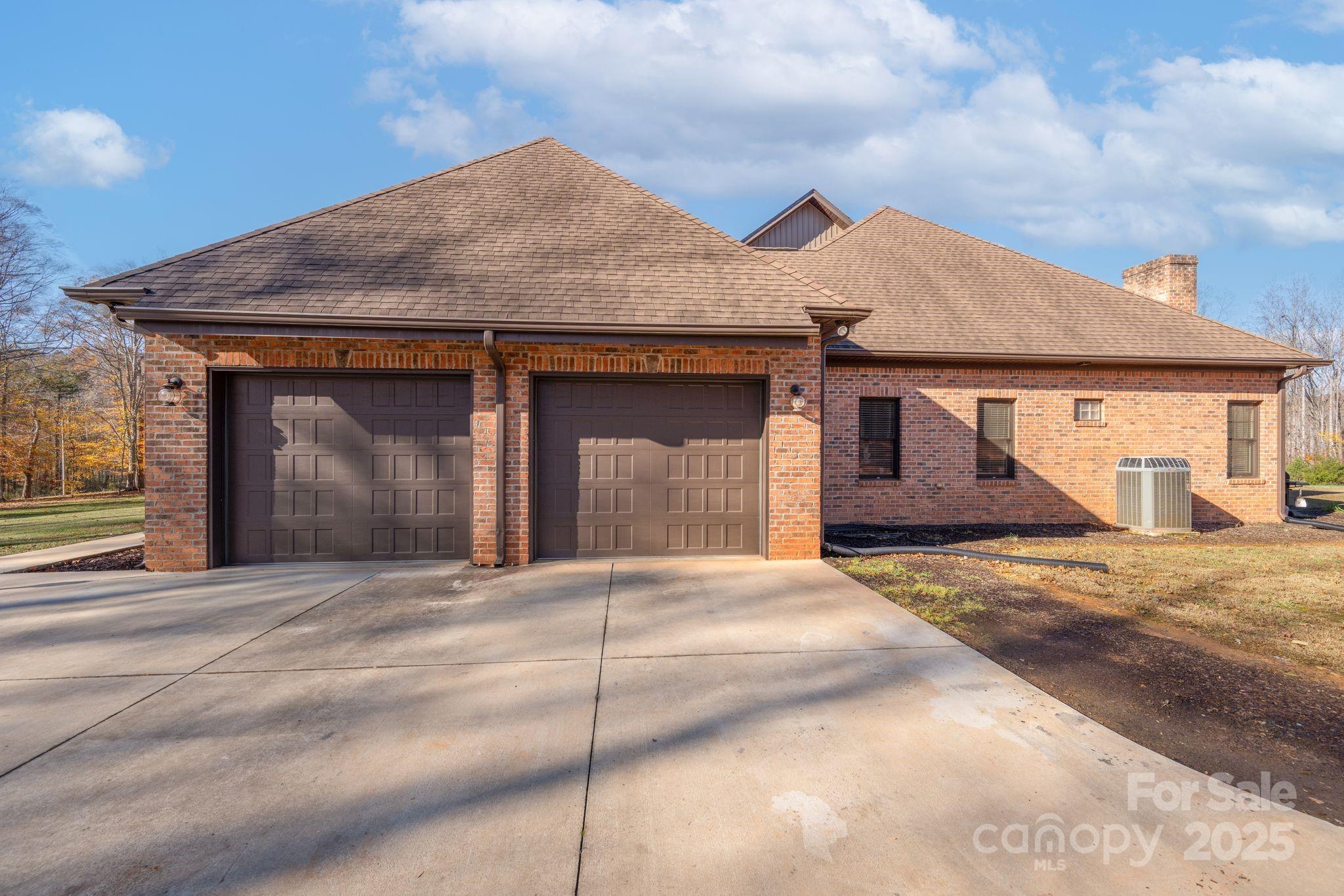476 Ijames Church Road Mocksville, NC 27028 - Photo 38 of 48 a front view of a house with a yard and garage