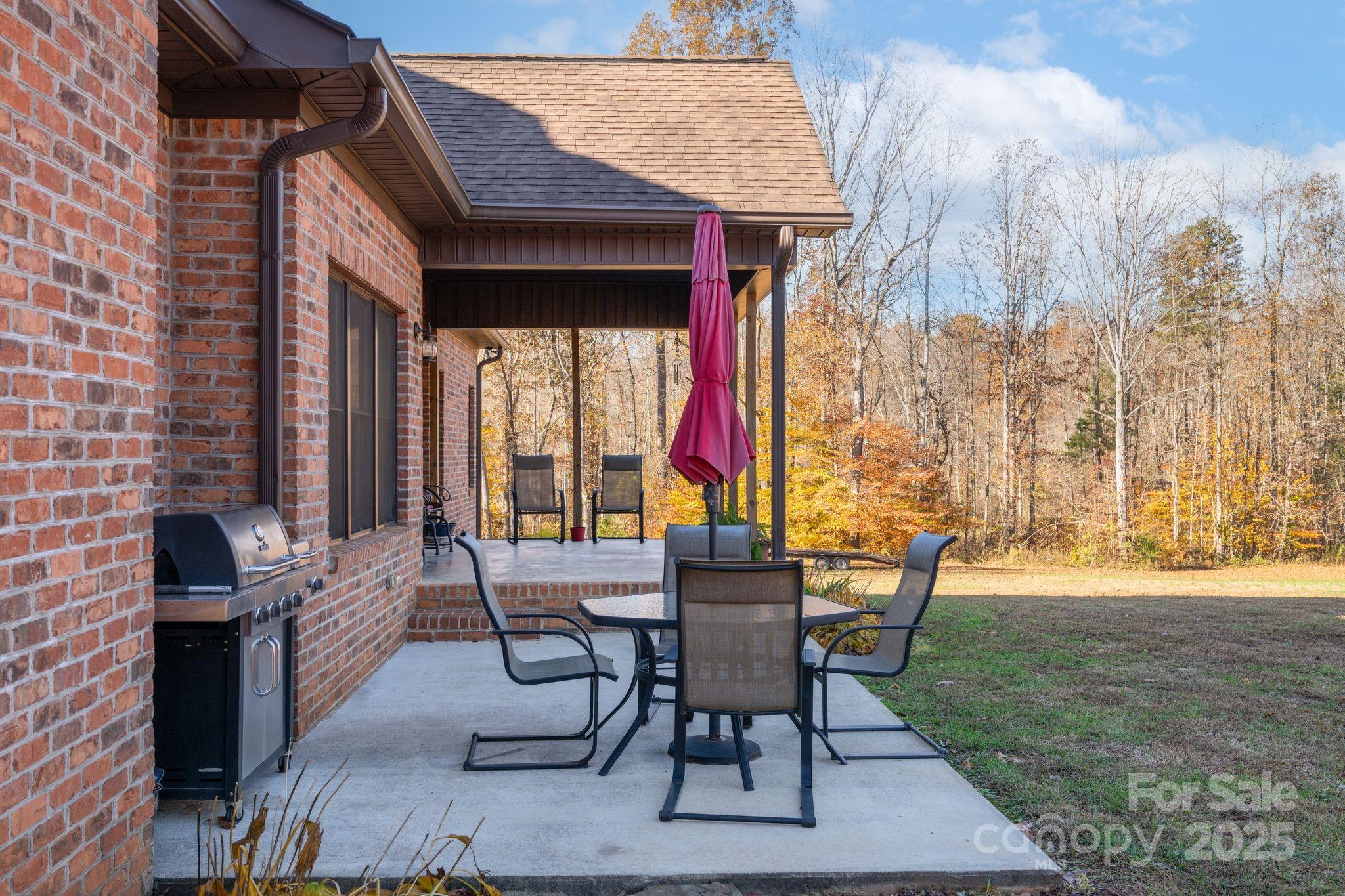 476 Ijames Church Road Mocksville, NC 27028 - Photo 40 of 48 a view of a patio with table and chairs and potted plants
