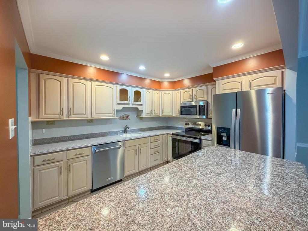 1680 Huntingdon Pike, Unit CONDO 232 Huntingdon Valley, PA 19006 - Photo 13 of 34 a kitchen with stainless steel appliances granite countertop a refrigerator sink and cabinets