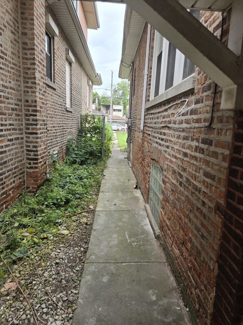 8220 South Prairie Avenue Chicago, IL 60619 - Photo 2 of 2 a pathway of a house with a yard