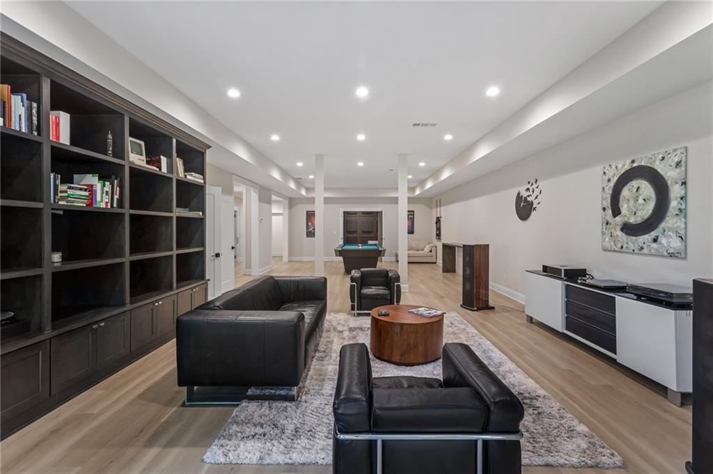 1050 Little River Lane Milton, GA 30004 - Photo 54 of 95 a living room with furniture and a book shelf