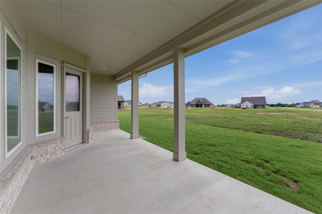 2204 Continent Court Krum, TX 76249 - Photo 24 of 28 Covered concrete patio with recessed lighting, stone veneer accents, multiple windows, and a glass-paneled door