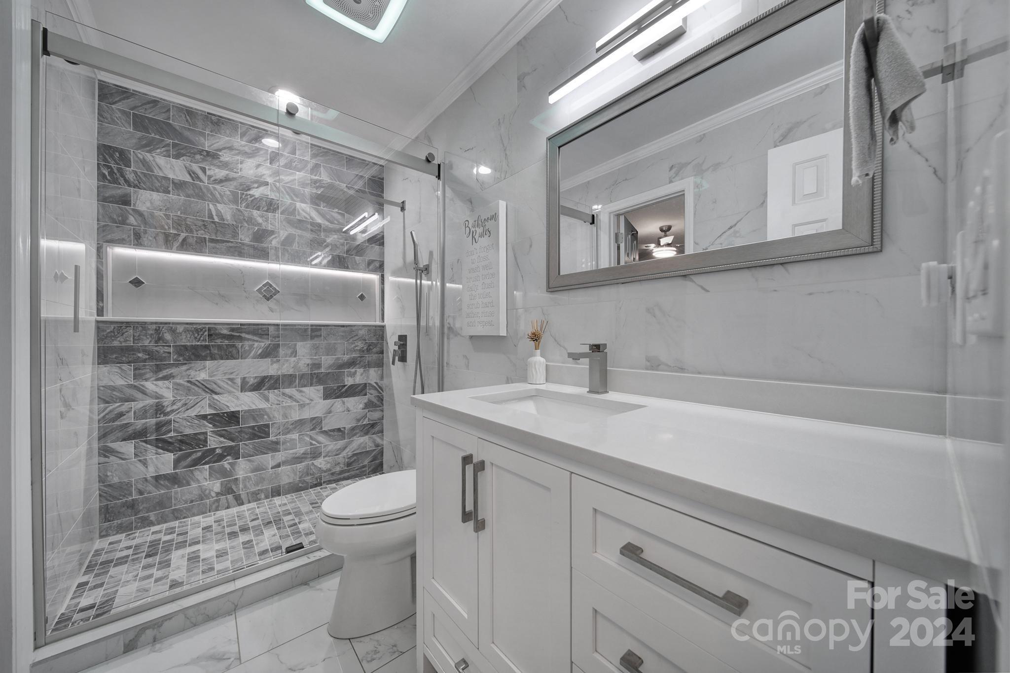 9119 Windjammer Drive Tega Cay, SC 29708 - Photo 11 of 40 a bathroom with a sink a toilet and shower