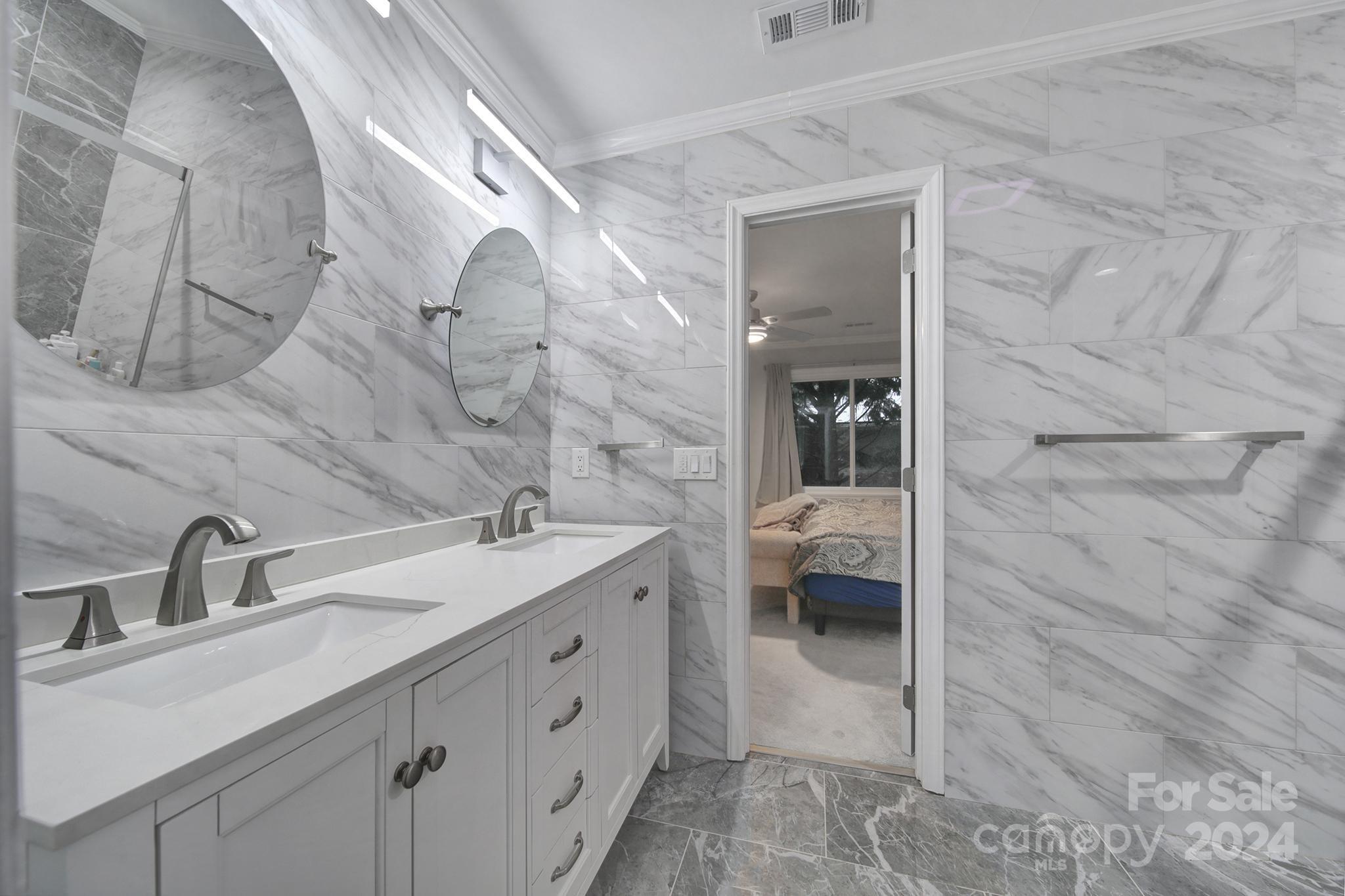 9119 Windjammer Drive Tega Cay, SC 29708 - Photo 18 of 40 a en suite bathroom with a sink and a mirror