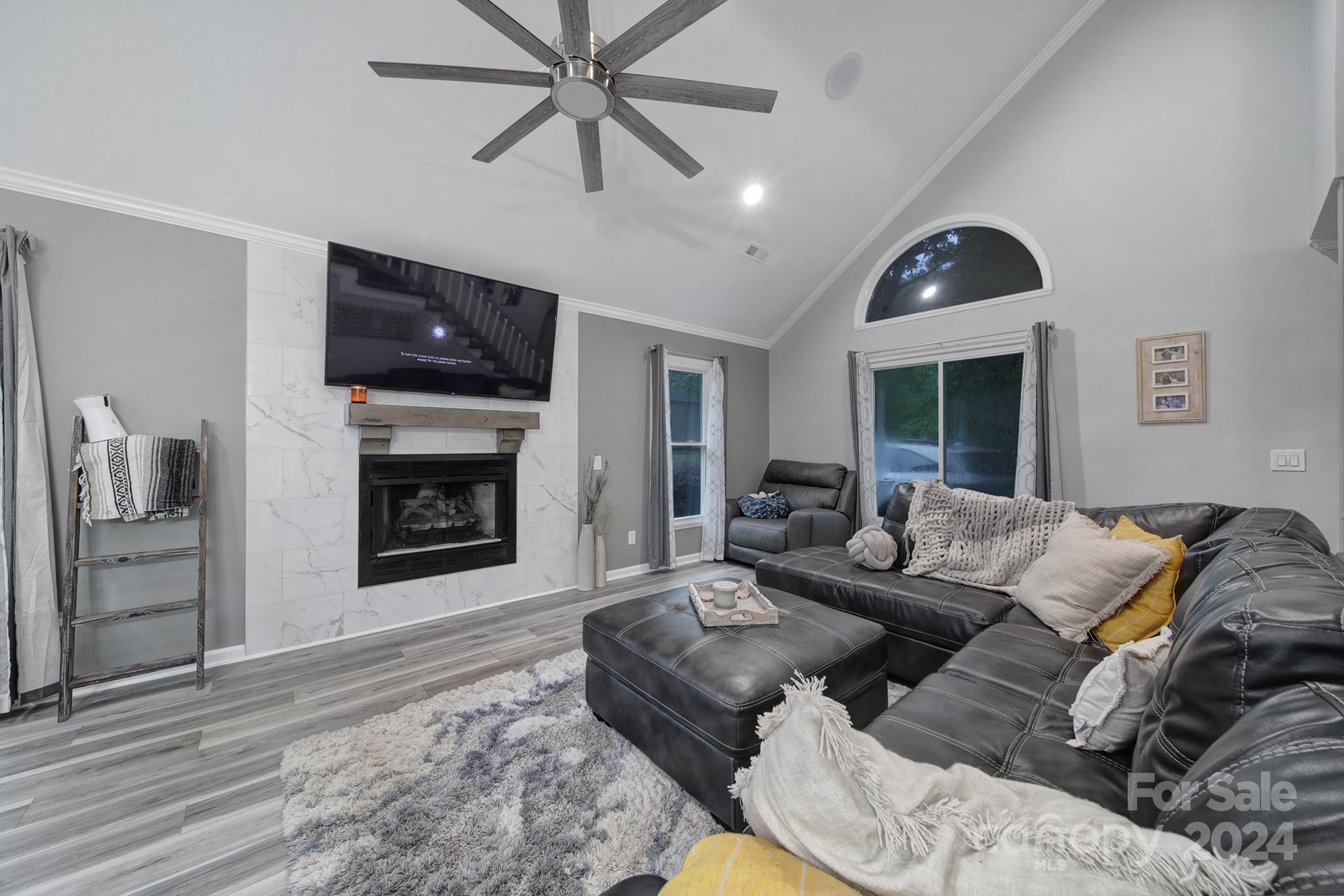 9119 Windjammer Drive Tega Cay, SC 29708 - Photo 5 of 40 a living room with furniture and a fireplace