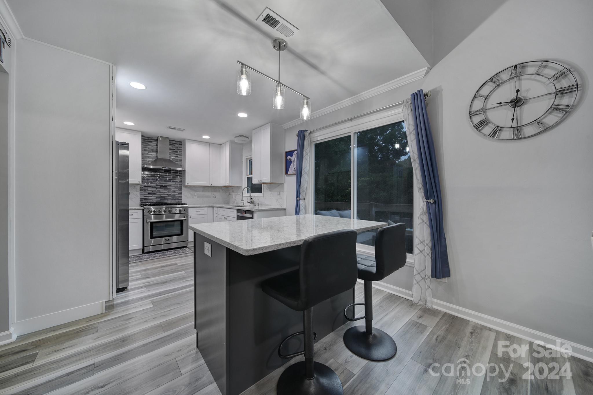 9119 Windjammer Drive Tega Cay, SC 29708 - Photo 7 of 40 a kitchen with stainless steel appliances granite countertop a sink and cabinets