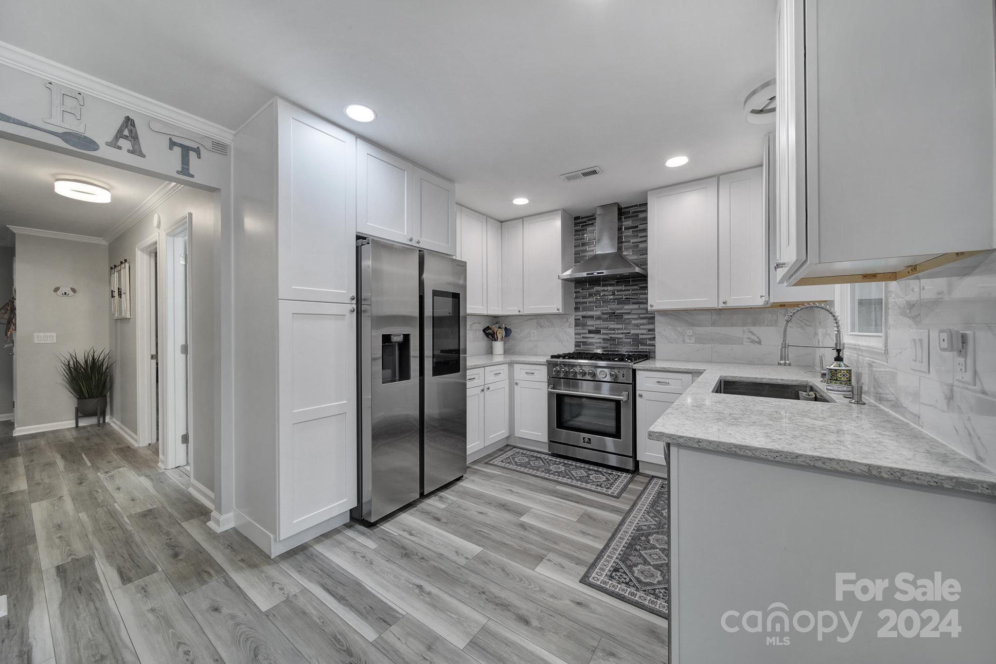 9119 Windjammer Drive Tega Cay, SC 29708 - Photo 9 of 40 a kitchen with a refrigerator sink and cabinets