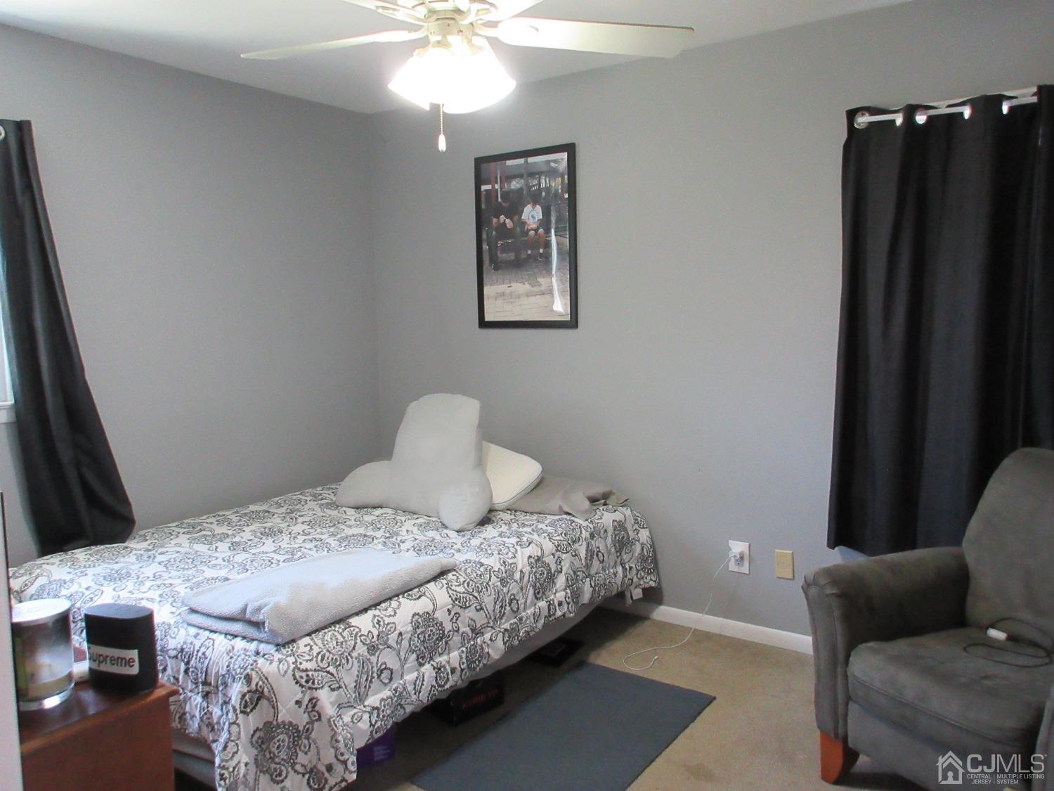 406 Chestnut Street Middlesex, NJ 08846 - Photo 11 of 16 a bedroom with a bed and a lamp with wooden floor